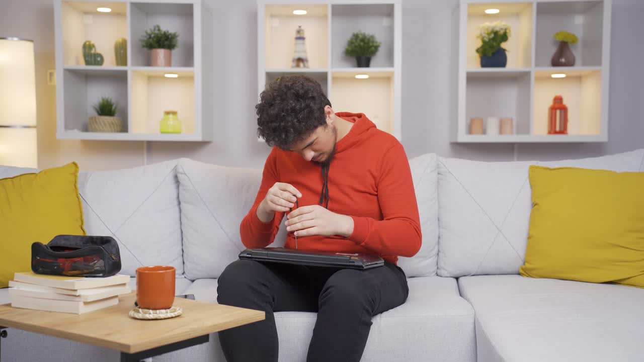 The man trying to fix the broken item.