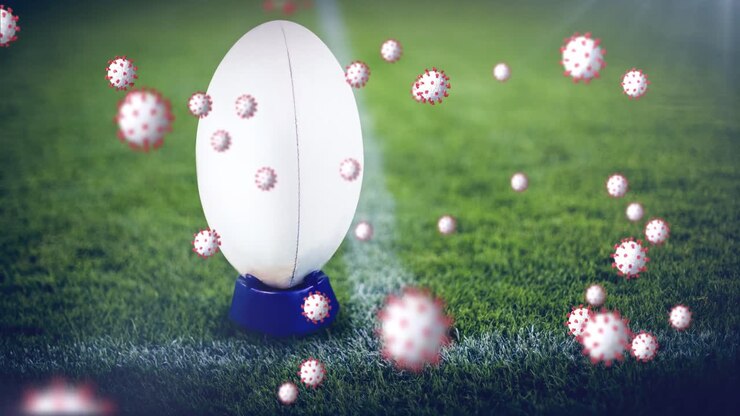 Animazione di cellule virali su un pallone da rugby in uno stadio