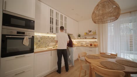 loving couple making a sandwich in kitchen-living room