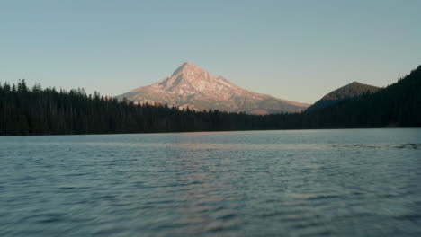 low aerial shot over lost lake as the sunset light hits mount hood