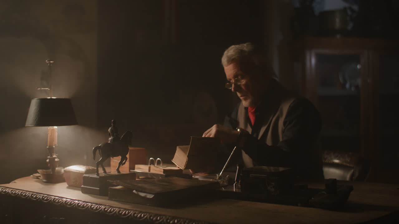 Old passionate man read a book in his office at night
