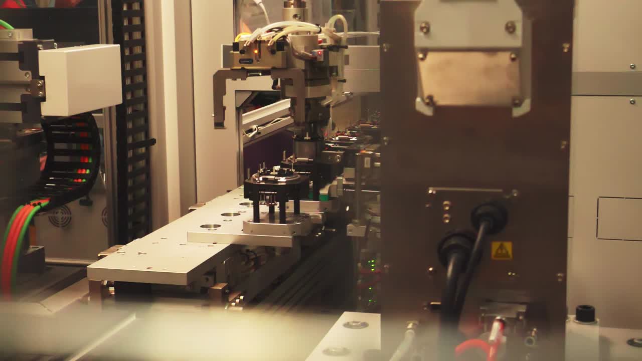 Manufacturing machinery at vehicle technology factory, close pan