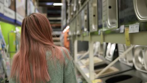 Woman-Is-Choosing-A-New-Kitchen-Sink-In-A-Store