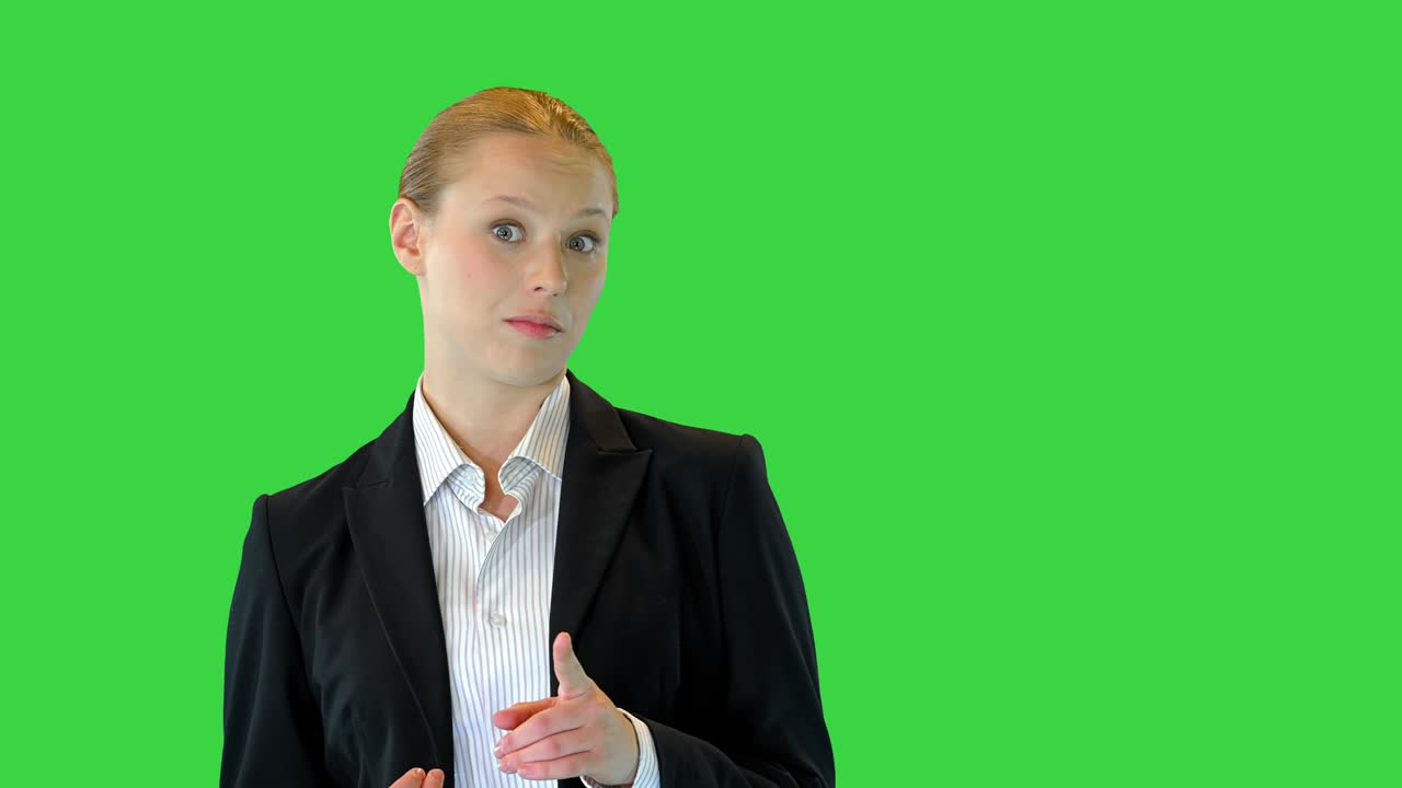 Young blonde businesswoman explaining something on a Green Screen, Chroma Key