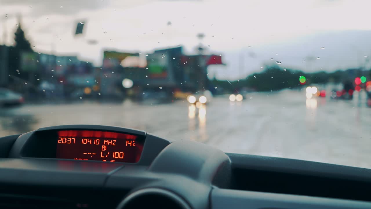 Control panel in the car close-up. Windscreen at the time of the rain.