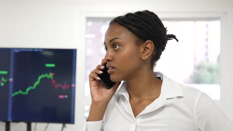 young black african business trader woman in an office call and talking about business and financial advising on the phone