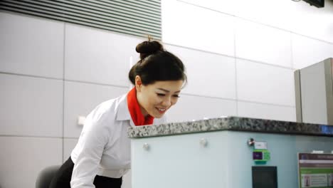 Airline-check-in-attendant-handing-passport-to-commuter-4k