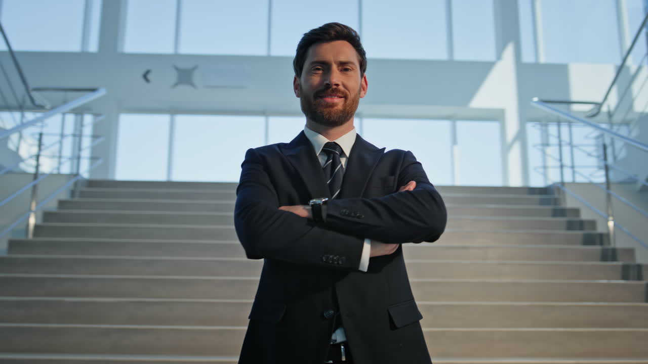 Successful executive standing staircase office hall closeup. Smiling businessman