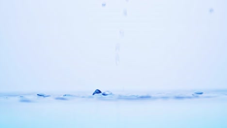 water splash surface filling the frame with slow motion the water drop and waving liquid with an air bubble on a white background