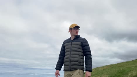 Young-man-hero-like-standing-against-dramatic-cloudy-sky