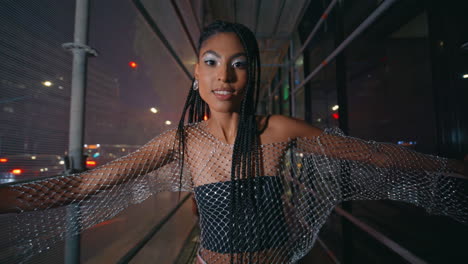 hot woman walking night scaffolding looking camera street portrait. girl posing