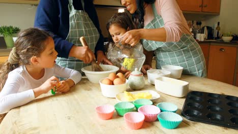 Siblings-preparing-food-with-family-in-kitchen-4k