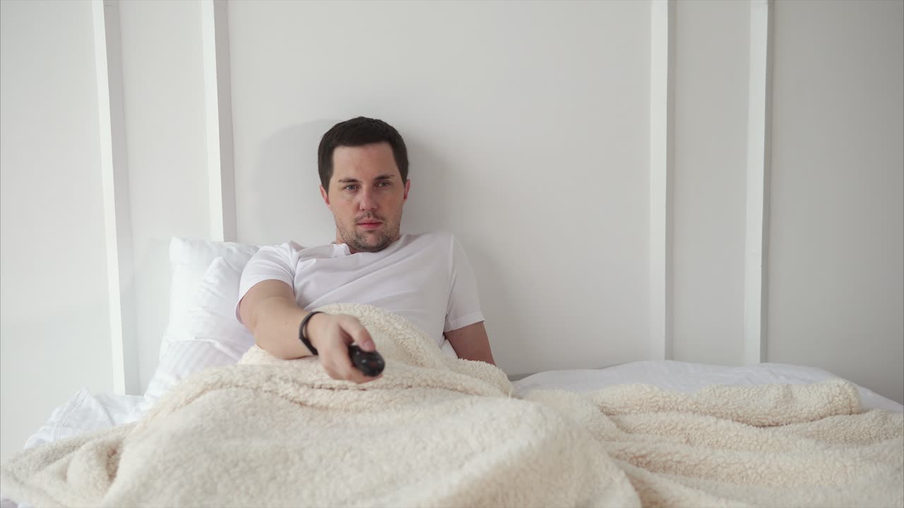 Man Watching TV in Bed