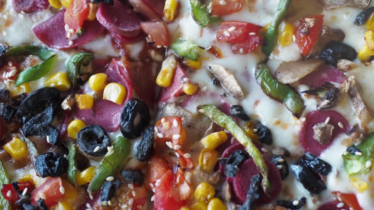 Close up of a loaded pizza