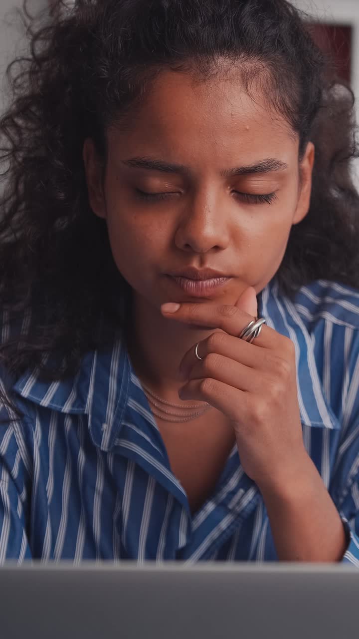 Thoughtful woman analyzes her thoughts in a cozy workspace