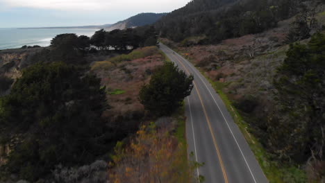 aerial of motorcyclist riding on california coast highway one