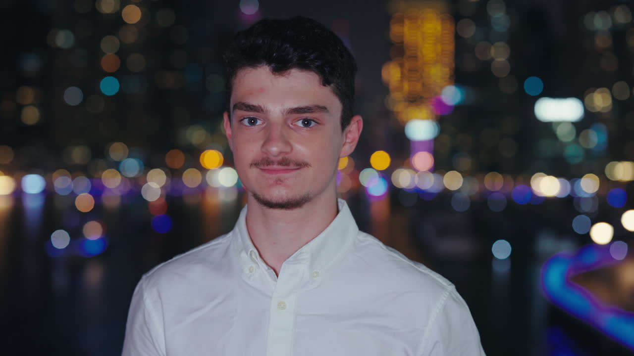 Portrait of a man in front of city lights