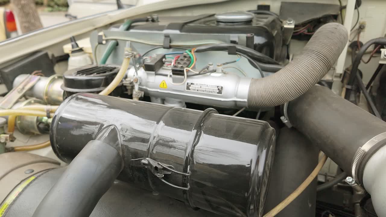 Under the hood auto mechanics and engine of East German classic car SLIDE shot