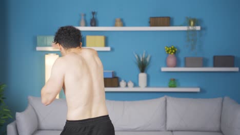 athlete young man practicing shadow boxing at home. healthy lifestyle.