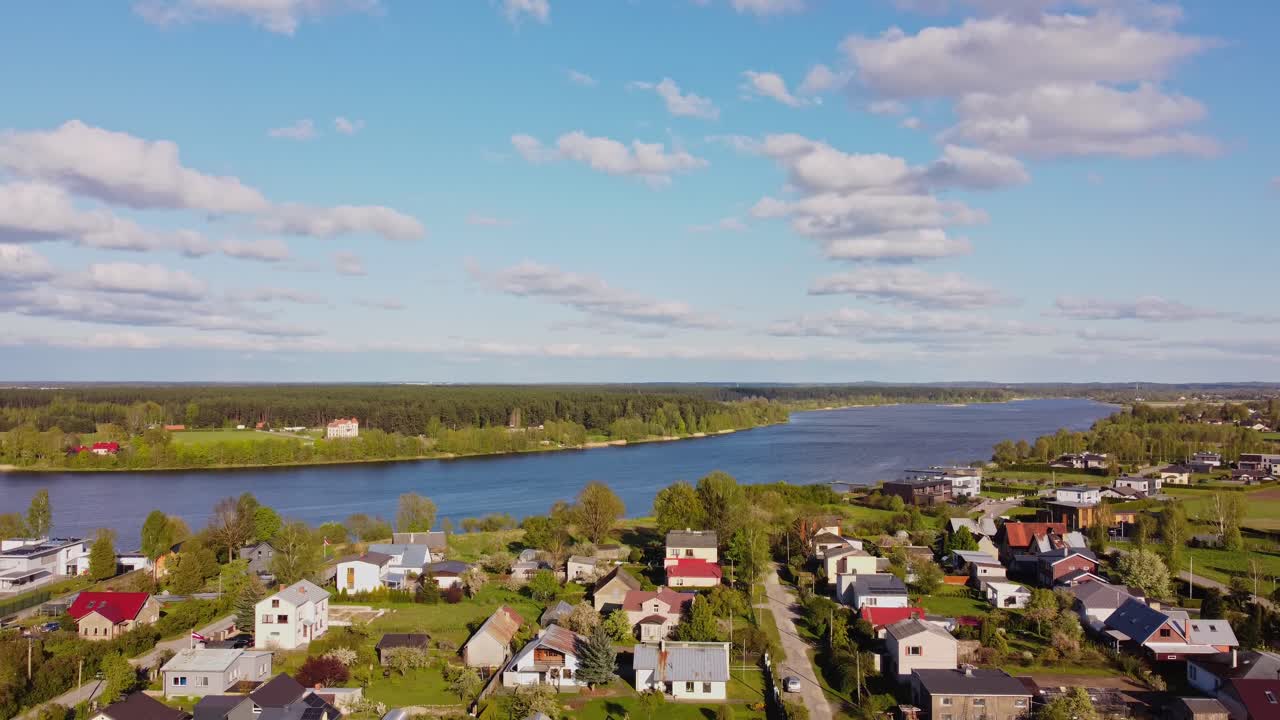 Katlakalns Spring Residential Area, nestled by a big river, surrounded by scenic nature.