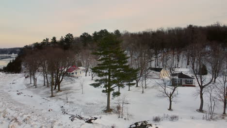 Aerial---Flying-over-the-frozen-shore-of-the-St-Lawrence-river-at-sunset-1