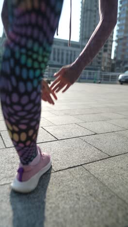 woman stretching outdoors in city