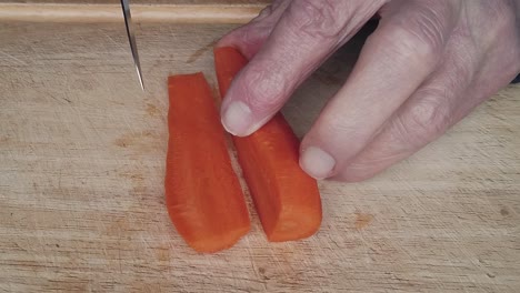 carrot being sliced and chopped to make a home made vegetable soup