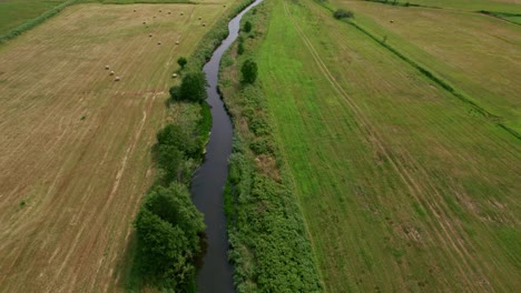 flying over a river to reveal a seashore in polish nature reserve "beka"