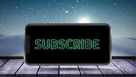 digital animation of subscribe neon text on smartphone screen on wooden surface against snow falling