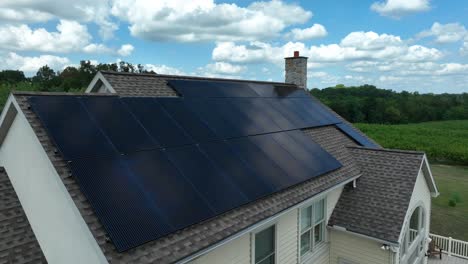 solar panels on house with shingle roof on bright sunny day