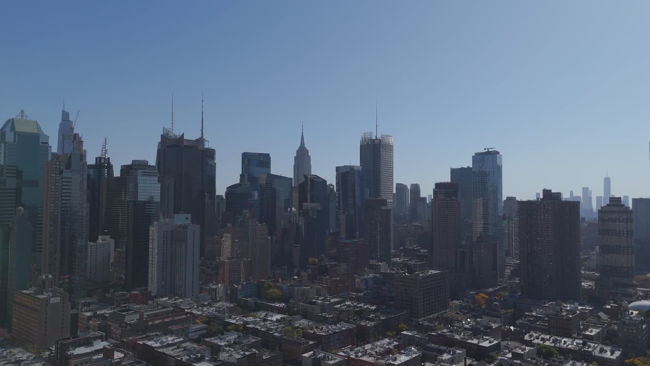 Aerial drone view of a Sunny and perfectly clear view of Manhattan New York City, with the Empire State Building and The One Trade Center skyscraper on the background