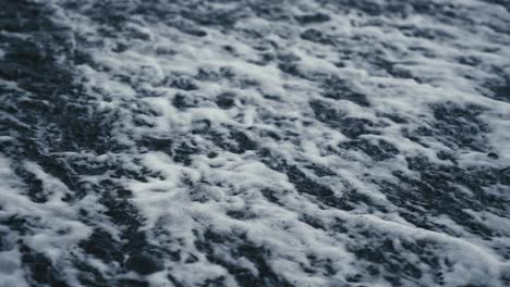 Close-up-on-foaming-water-ripples