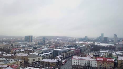 upwards aerial movement revealing the old town of vilnius during a snowstorm