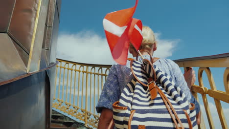 a tourist with a backpack and the flag of denmark rises up the famous spiral staircase of the church