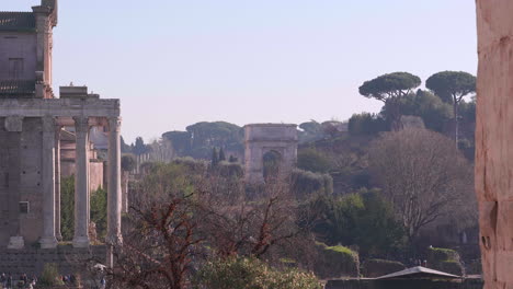 Bird-flying-thru-the-Roman-Forum,-Rome-Italy