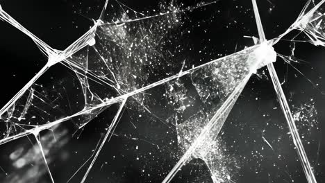 Close-up video shot of shattered glass, showcasing intricate cracks and reflections