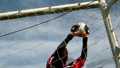 Goalkeeper-in-red-saving-a-goal-during-a-game