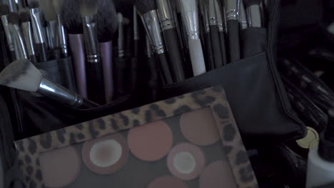 range of makeup artist's brushes laid out. medium reveal shot