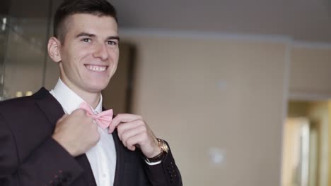 elegant groom in wedding jacket. handsome groom in suit. wedding morning