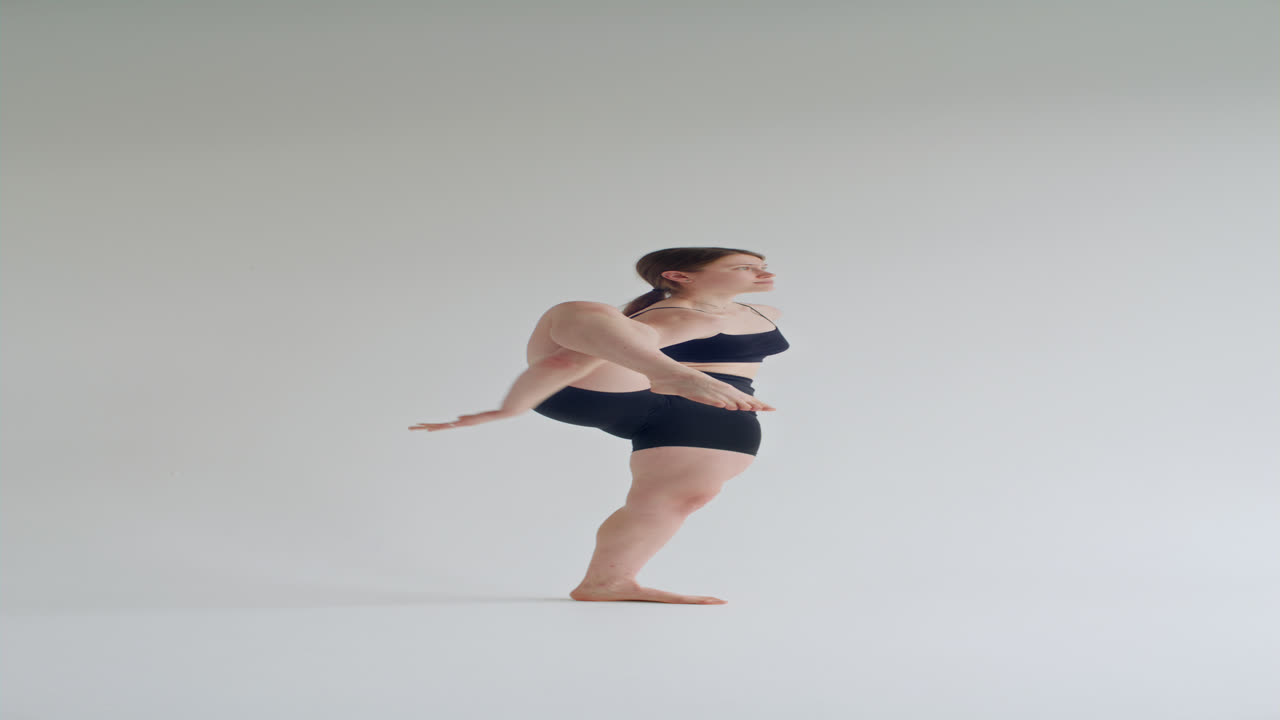 Woman Performing Standing Compass Pose during Yoga Session in Studio
