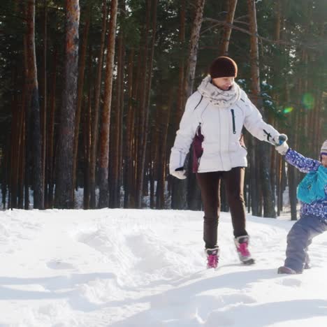 mother walks with her two children in snow 04