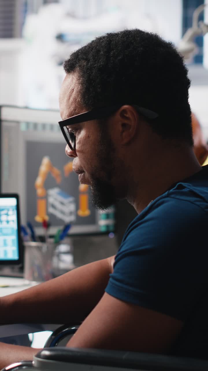 Vertical Video African american wheelchair user working in solar panel factory