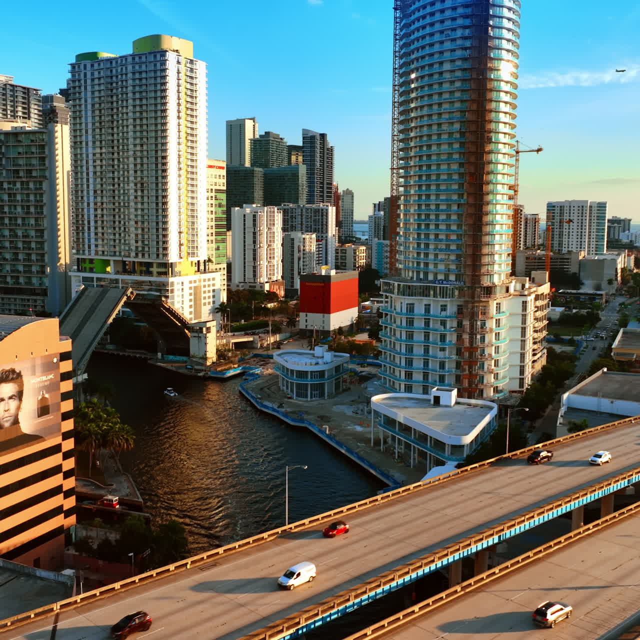Three freeways on the over the river in metropolis. Cars run by the highways in downtown of Miami, Florida, USA.