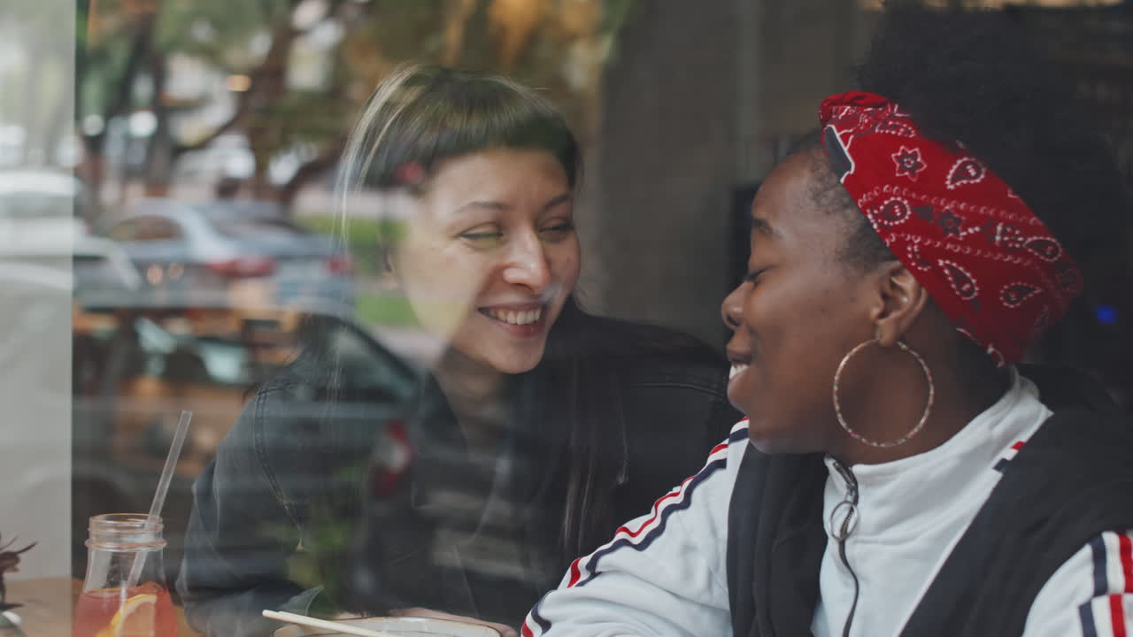 Happy Queer Couple Chatting in Cafe and Hugging