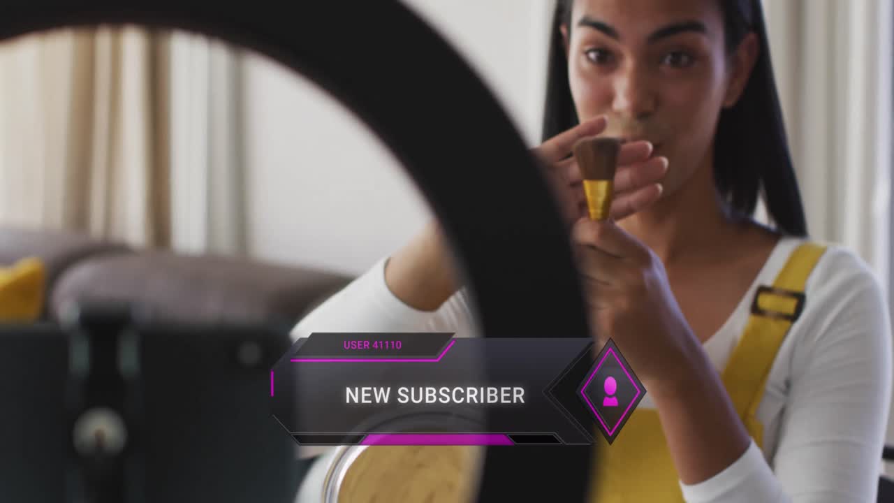 Animation of social media data and icons over biracial woman on makeup vlog