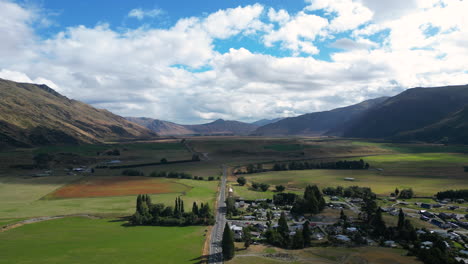 aerial view of a the main road going through the small town of kingston new zealand, ascending shot