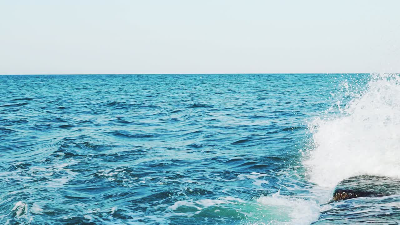 rough sea on the background of clear sky. Slow motion. Sea waves. Aerial view