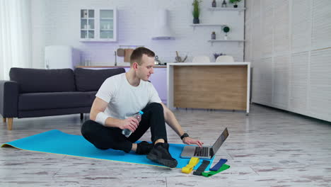 handsome young sportsman doing exercises on quarantine. lifestylish athelic active man training indoors.