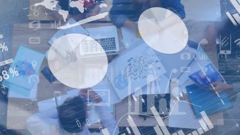 composición digital del procesamiento de datos financieros frente a la vista superior de las personas que trabajan en la oficina