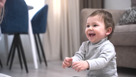 Mother-And-Baby-Playing-On-The-Floor-At-Home